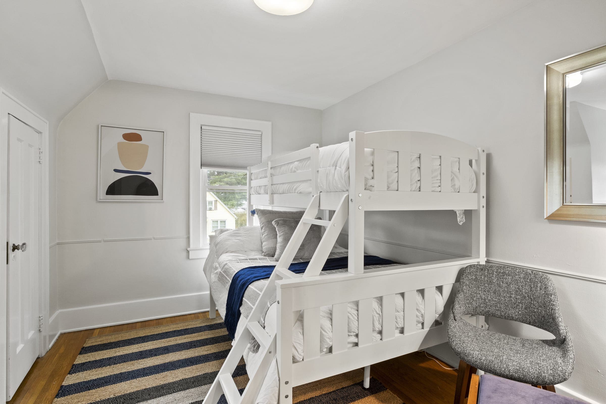 Bunk room with a bunk bed and reading chair