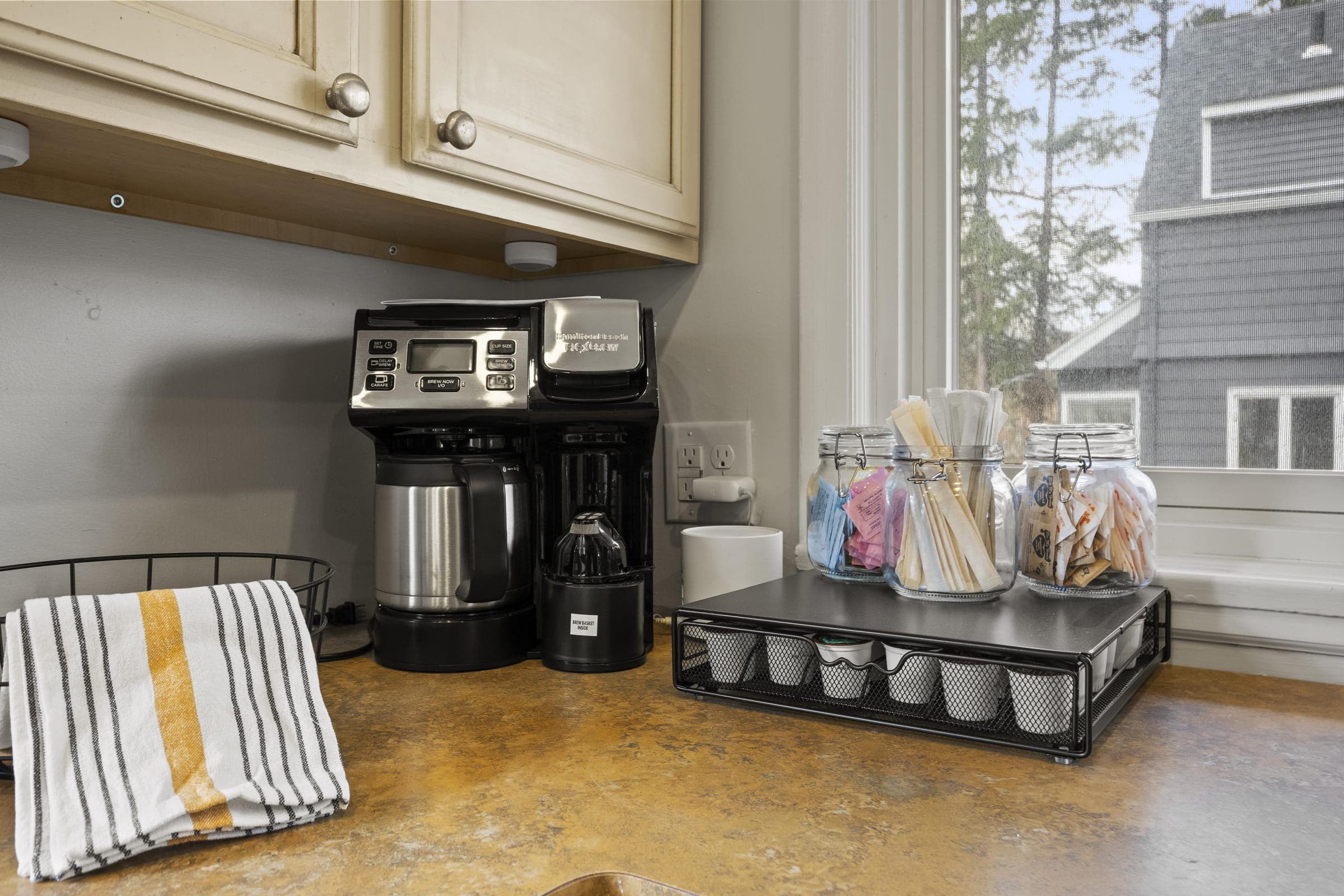 Coffee bar with a coffee maker and snack jars