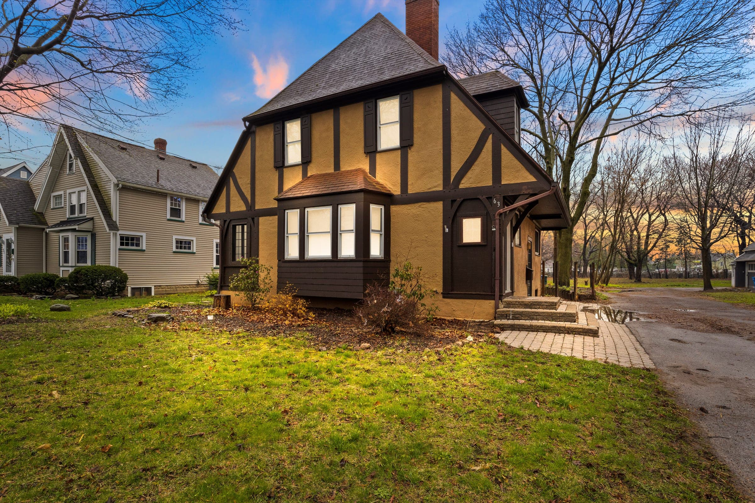 Tudor-style exterior of Ca’n Pearson at twilight